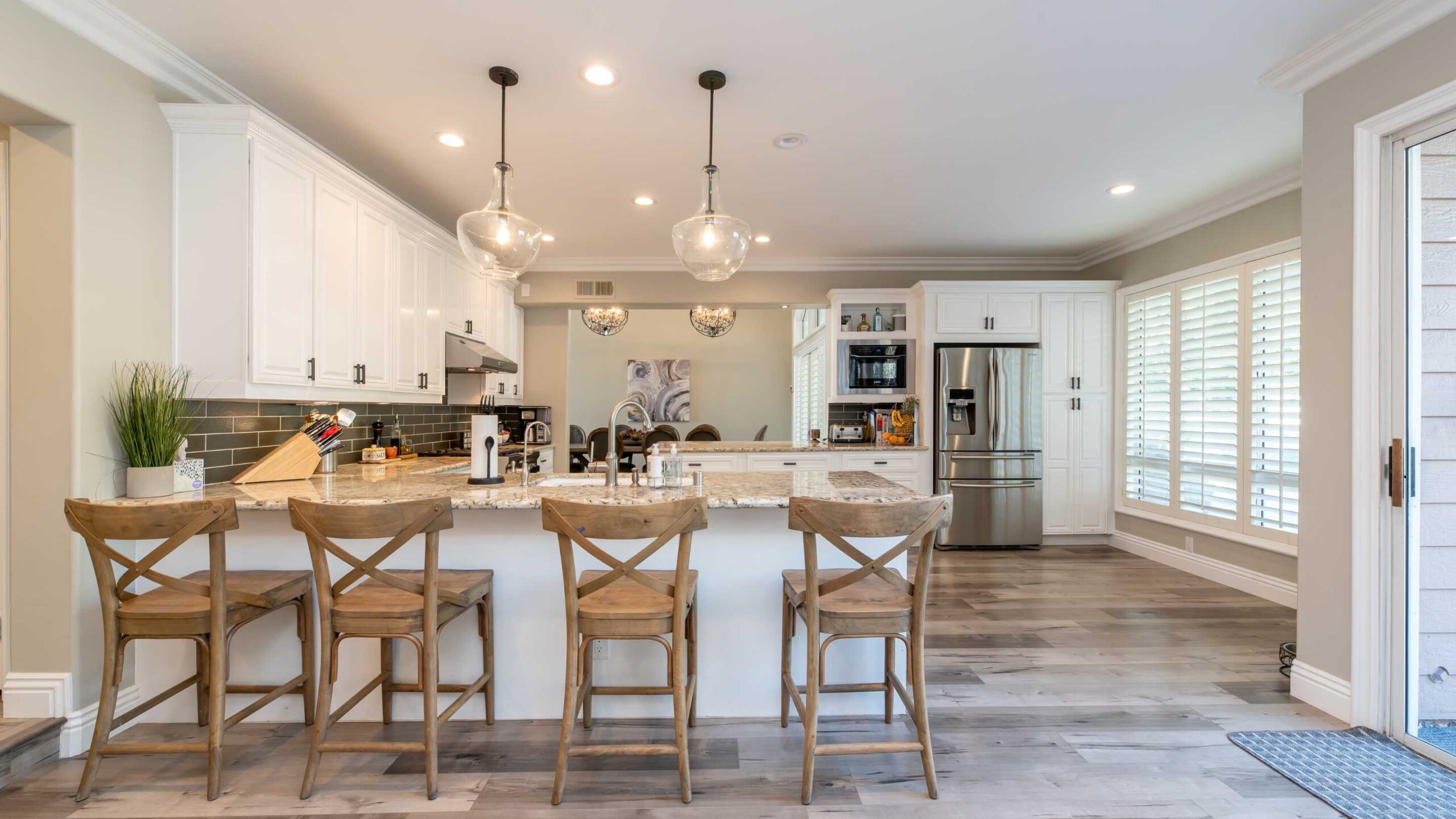 Kitchen and dining area with white cabinets